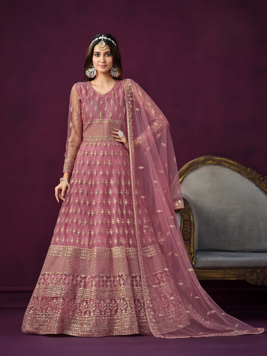 Pink net salwar kameez featuring heavy thread embroidery with zari and sequins work.