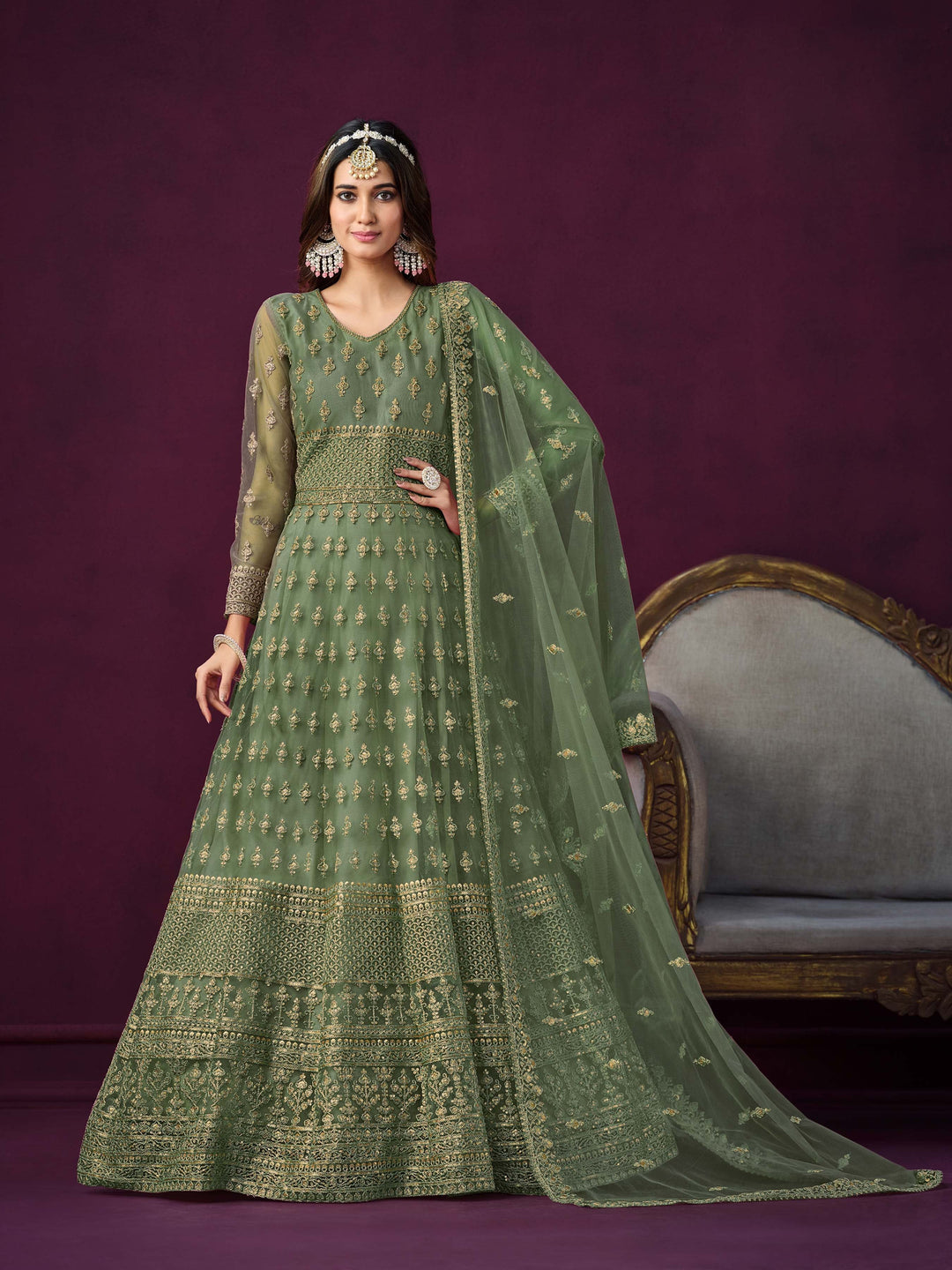 green net salwar kameez featuring heavy thread embroidery with zari and sequins work.