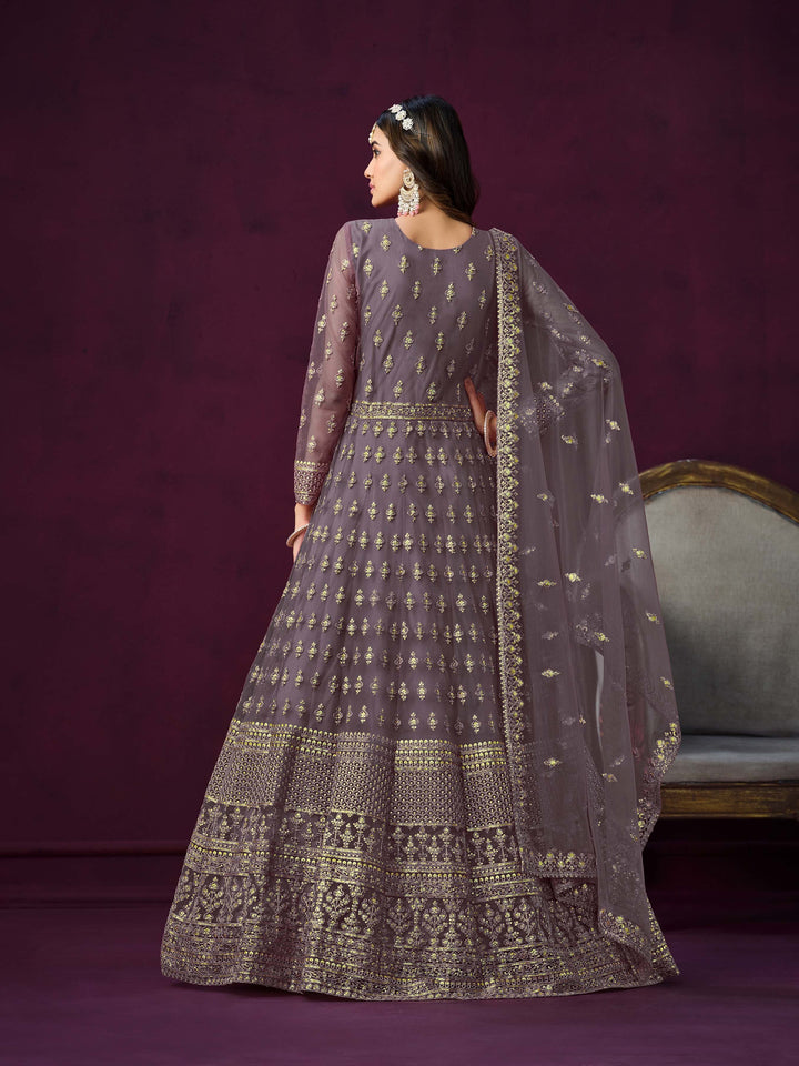 Chic dusty purple net salwar kameez with heavy embroidery and zari work, ideal for special occasions.