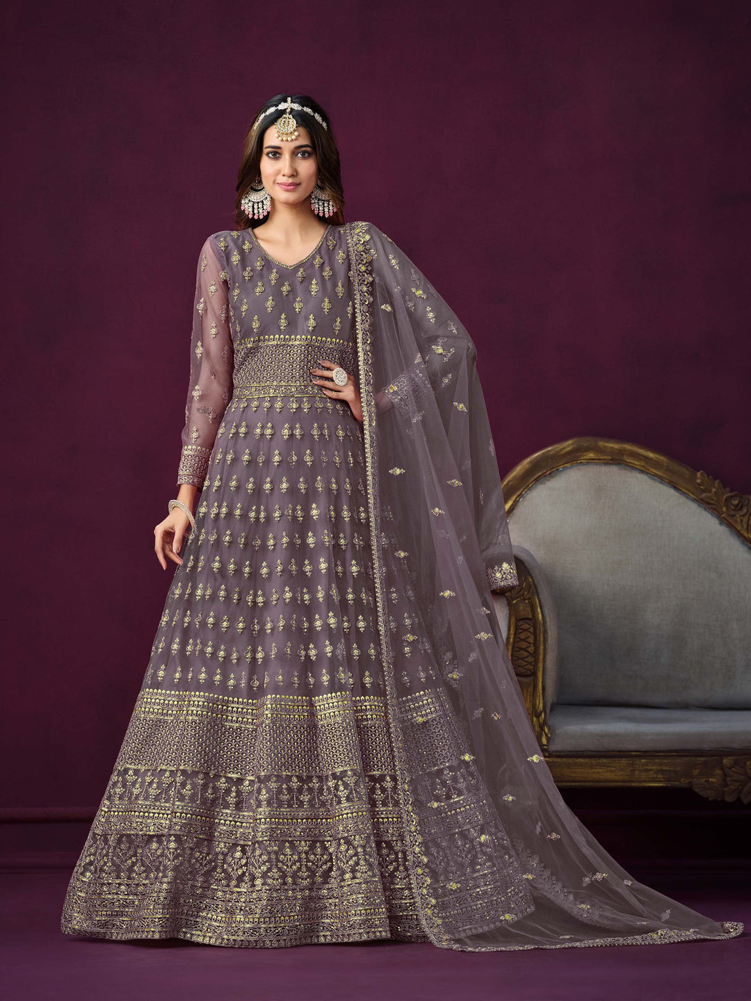 Dusty purple net salwar kameez featuring heavy thread embroidery with zari and sequins work.