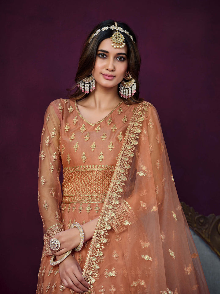 Luxurious coral salwar kameez showcasing exquisite detailing for weddings and events.