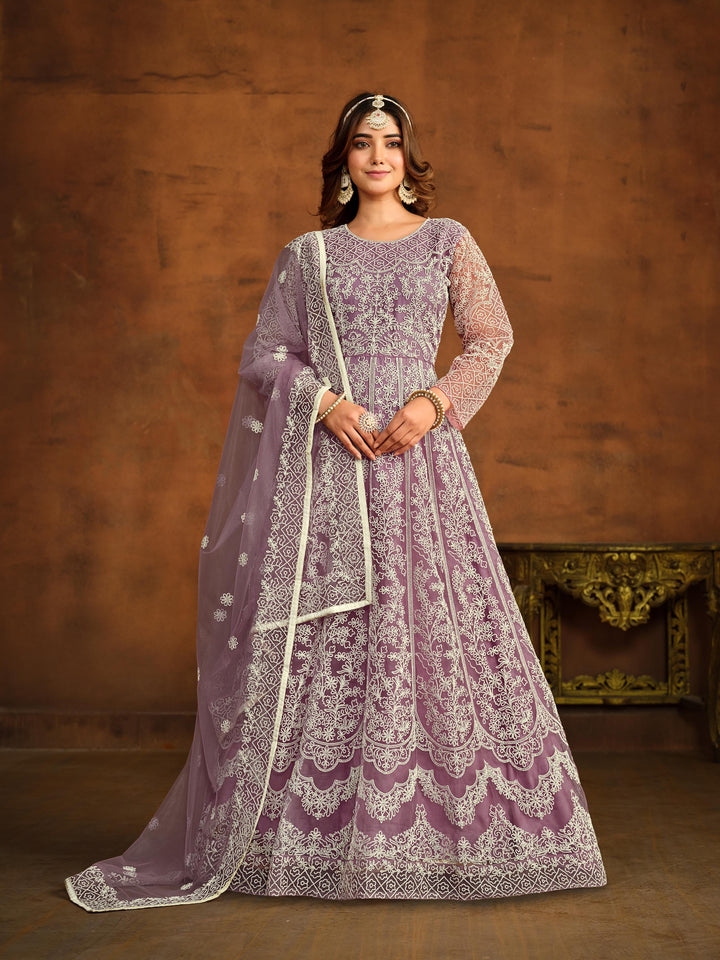 Light purple net salwar kameez featuring heavy thread embroidery work.