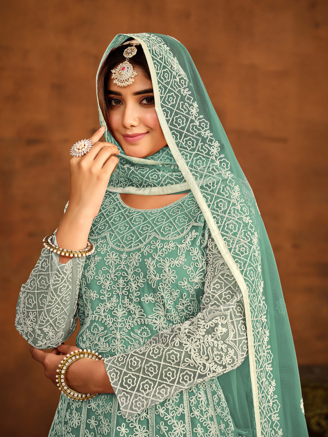 Chic sea green net salwar kameez with heavy embroidery work, ideal for special occasions.