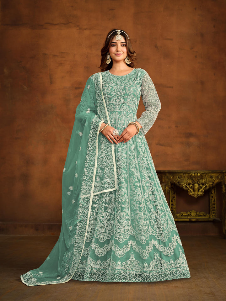 Sea green net salwar kameez featuring heavy thread embroidery work.