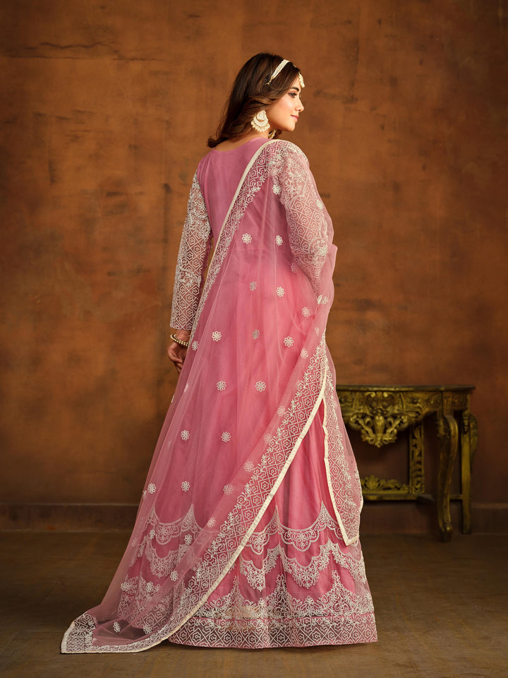 Luxurious pink salwar kameez showcasing exquisite detailing for weddings and events.