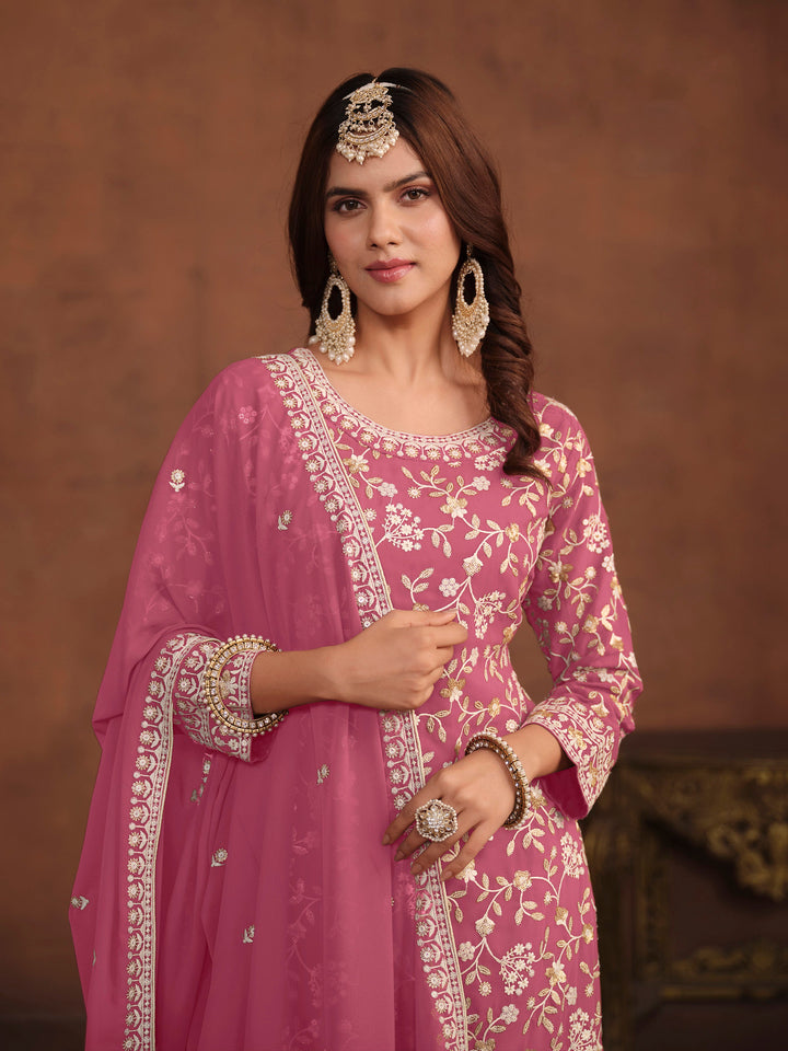 Traditional pink faux georgette salwar kameez, detailed embroidery and sequins for USA occasions.