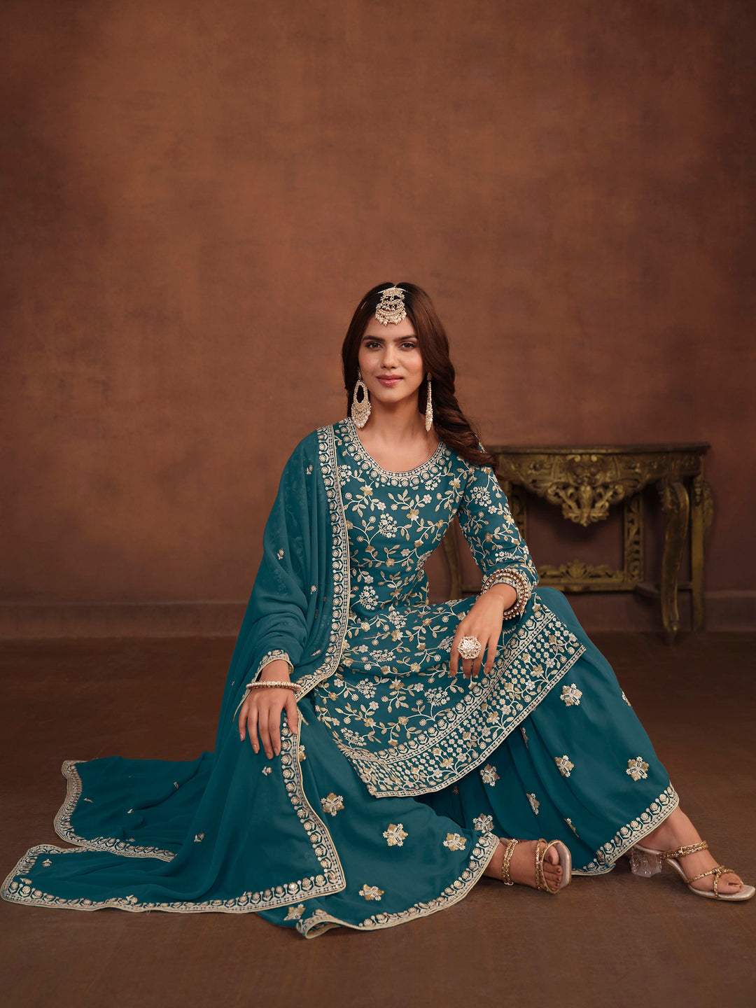 Teal faux georgette salwar kameez with intricate thread embroidery and sequins work, stylish for USA events.