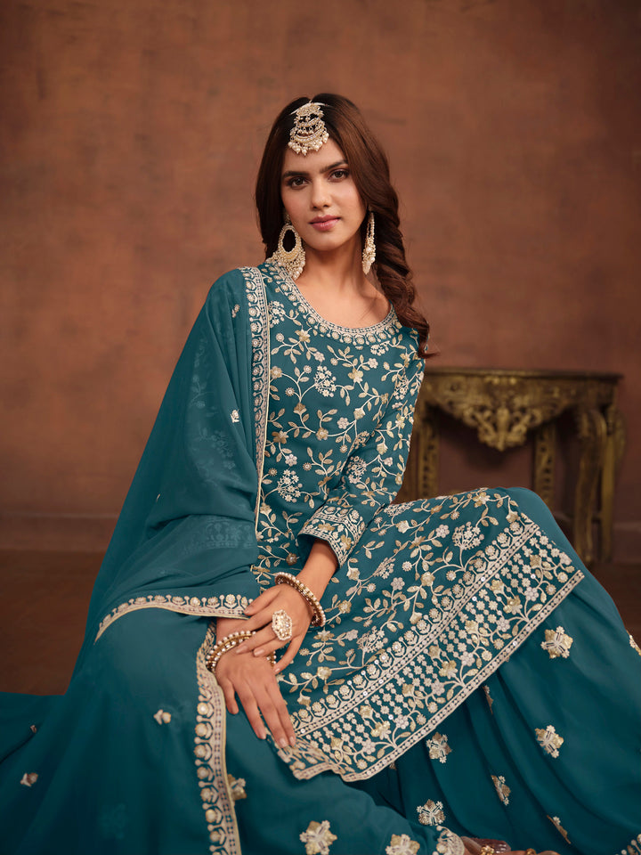 Designer teal salwar kameez in faux georgette, heavy embroidery with sequins for USA customers.