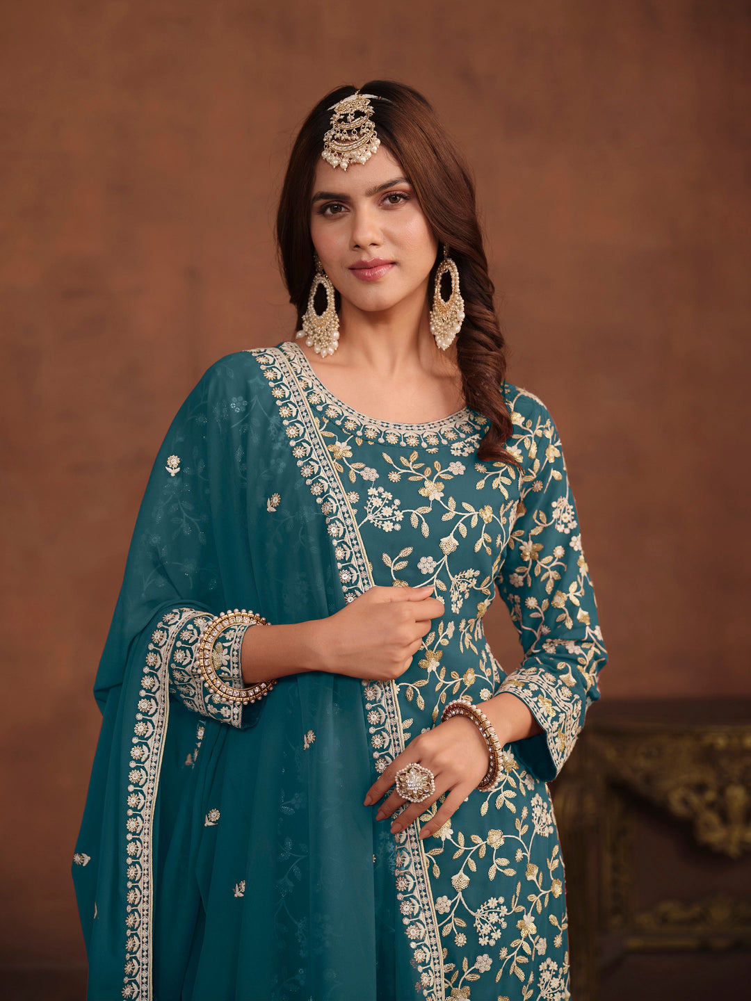 Traditional teal faux georgette salwar kameez, detailed embroidery with sequins for USA occasions.