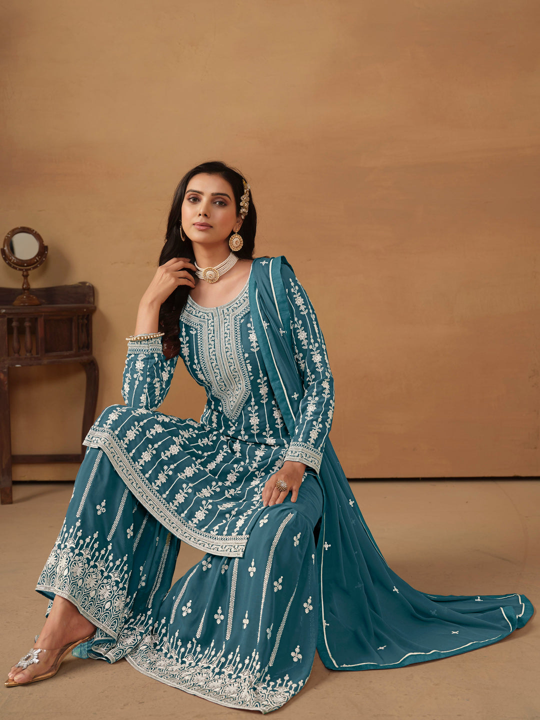 Beautiful teal salwar kameez crafted from faux georgette, showcasing exquisite heavy thread and sequin embellishments.