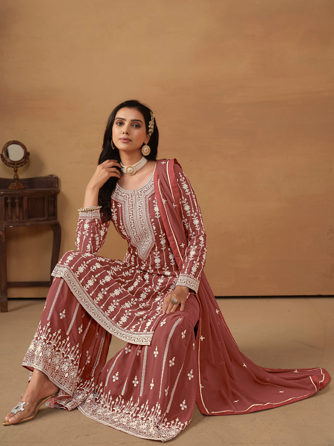 Beautiful chocolate salwar kameez crafted from faux georgette, showcasing intricate heavy thread and sequin embellishments.