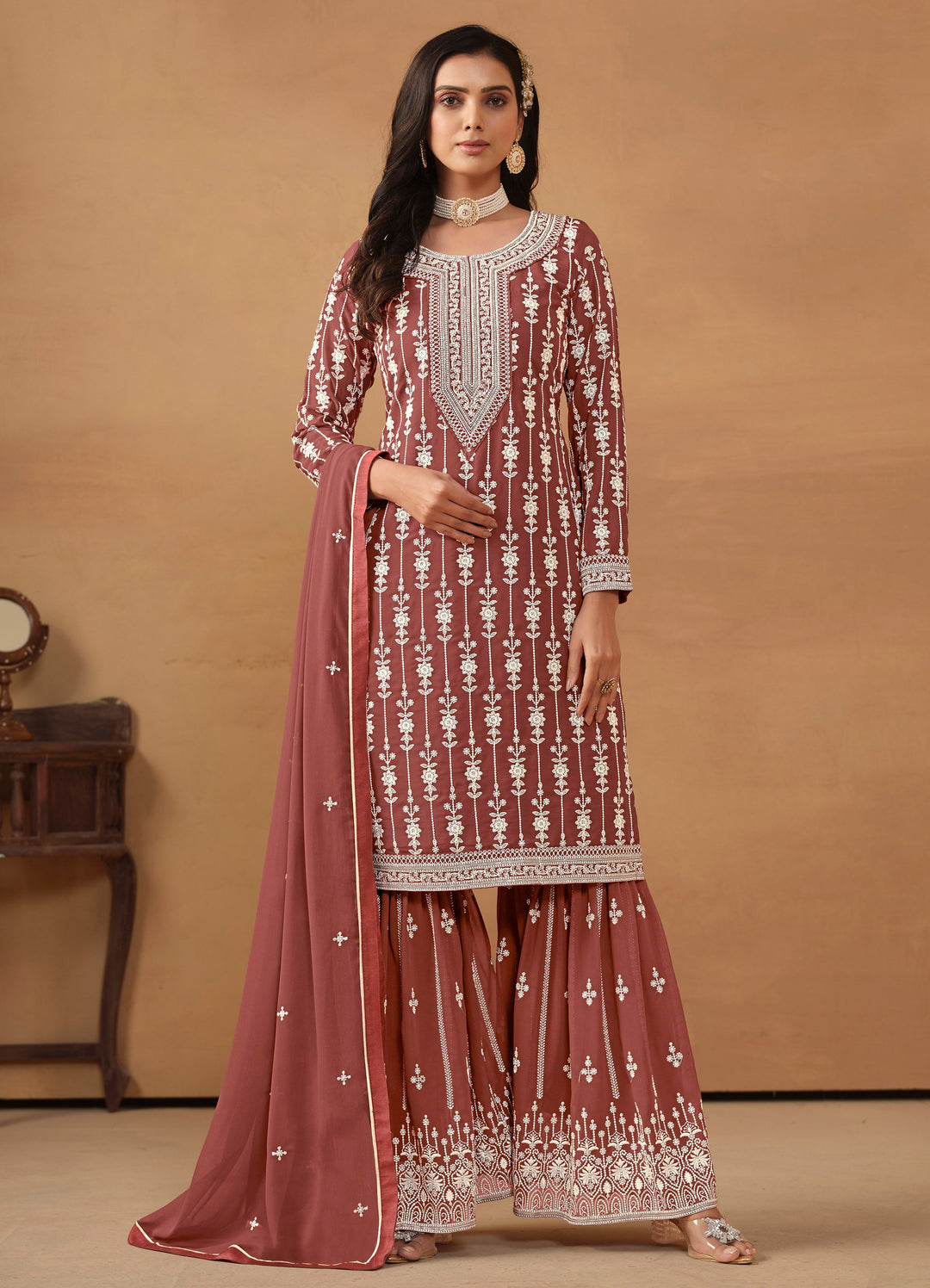 Elegant chocolate faux georgette salwar kameez featuring heavy thread embroidery and sequins, perfect for festive occasions.