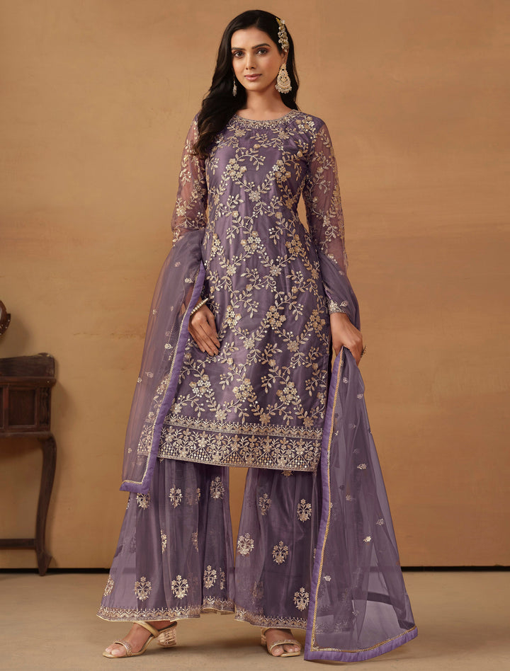 Elegant purple net salwar kameez featuring heavy thread embroidery and sequins, perfect for festive occasions.