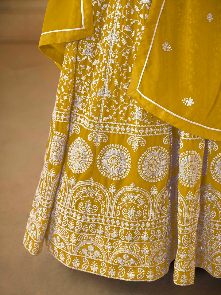 Beautiful mustard salwar kameez crafted from faux georgette, showcasing intricate heavy thread and sequin embellishments.