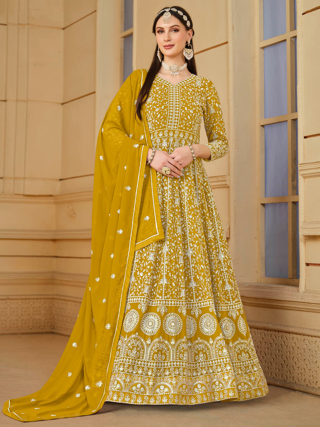 Elegant mustard faux georgette salwar kameez featuring heavy thread embroidery and sequins, perfect for festive occasions.