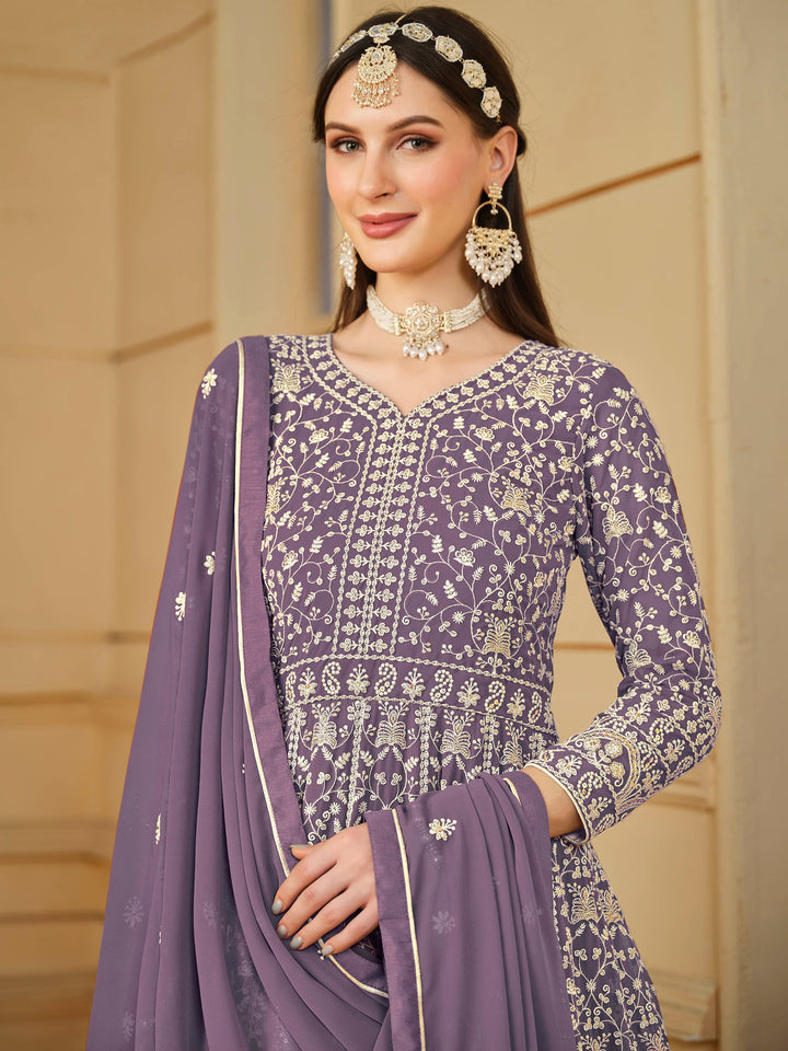 Stunning purple salwar kameez in faux georgette featuring intricate thread embroidery and shimmering sequins for special events.