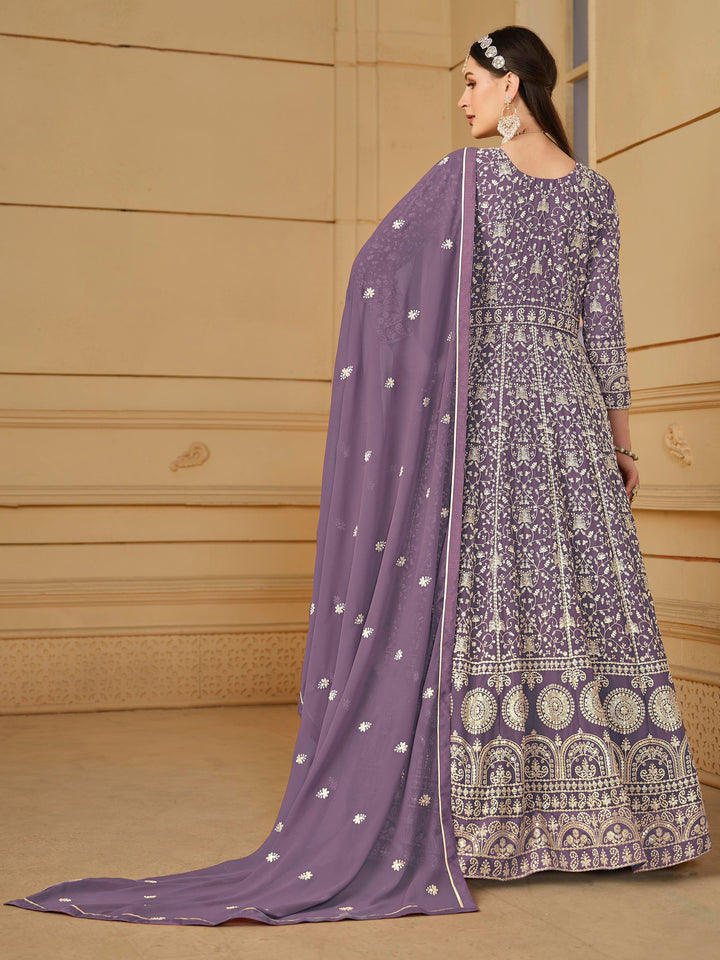 Luxurious purple faux georgette salwar kameez adorned with exquisite heavy embroidery and sequins, ideal for weddings and celebrations.