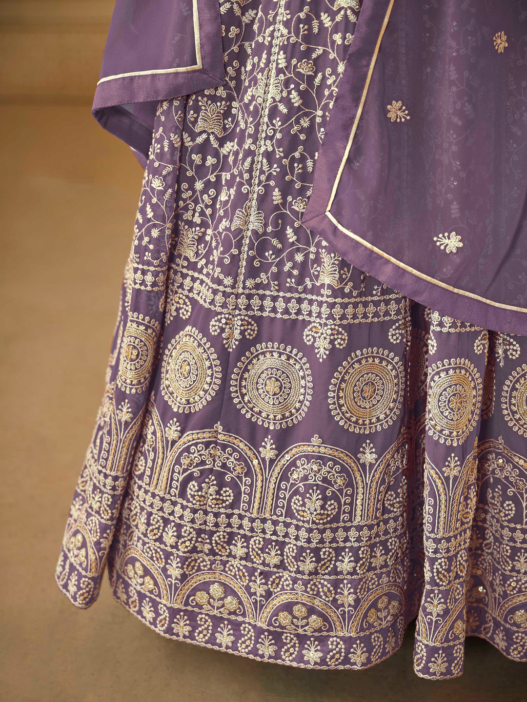 Beautiful purple salwar kameez crafted from faux georgette, showcasing intricate heavy thread and sequin embellishments.