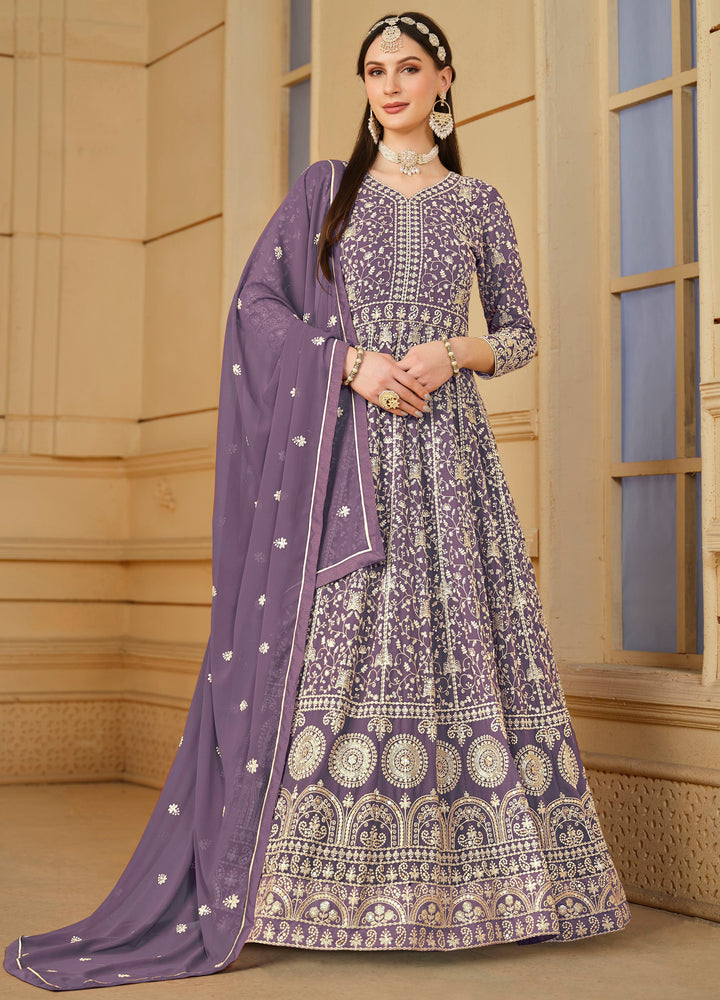 Elegant purple faux georgette salwar kameez with heavy thread embroidery and sequin work, perfect for festive occasions.