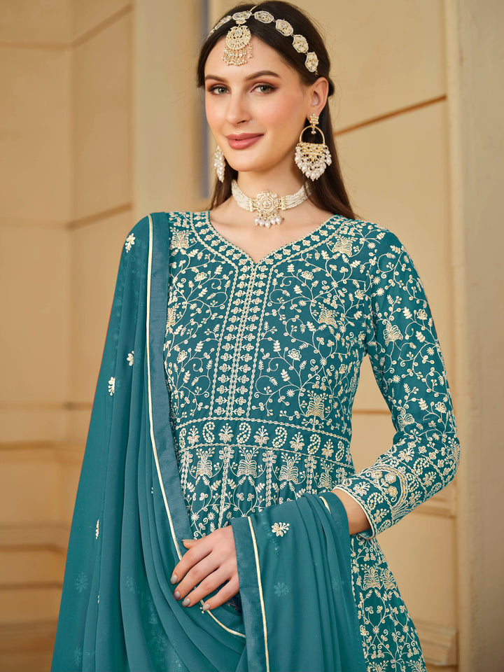 Stunning teal salwar kameez in faux georgette with intricate thread embroidery and shimmering sequin work for special events.