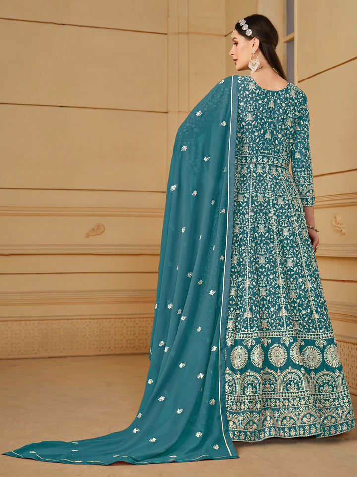 Luxurious teal faux georgette salwar kameez adorned with exquisite heavy embroidery and sequins, ideal for weddings and celebrations.