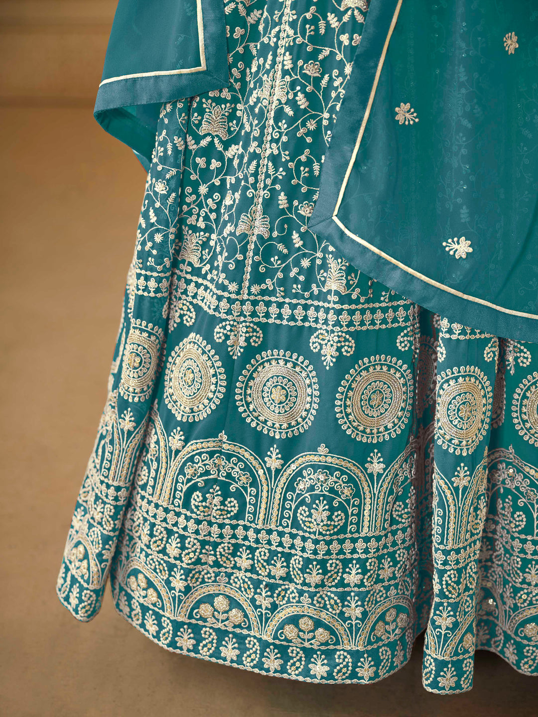 Beautiful teal salwar kameez crafted from faux georgette, showcasing intricate heavy thread and sequin embellishments.