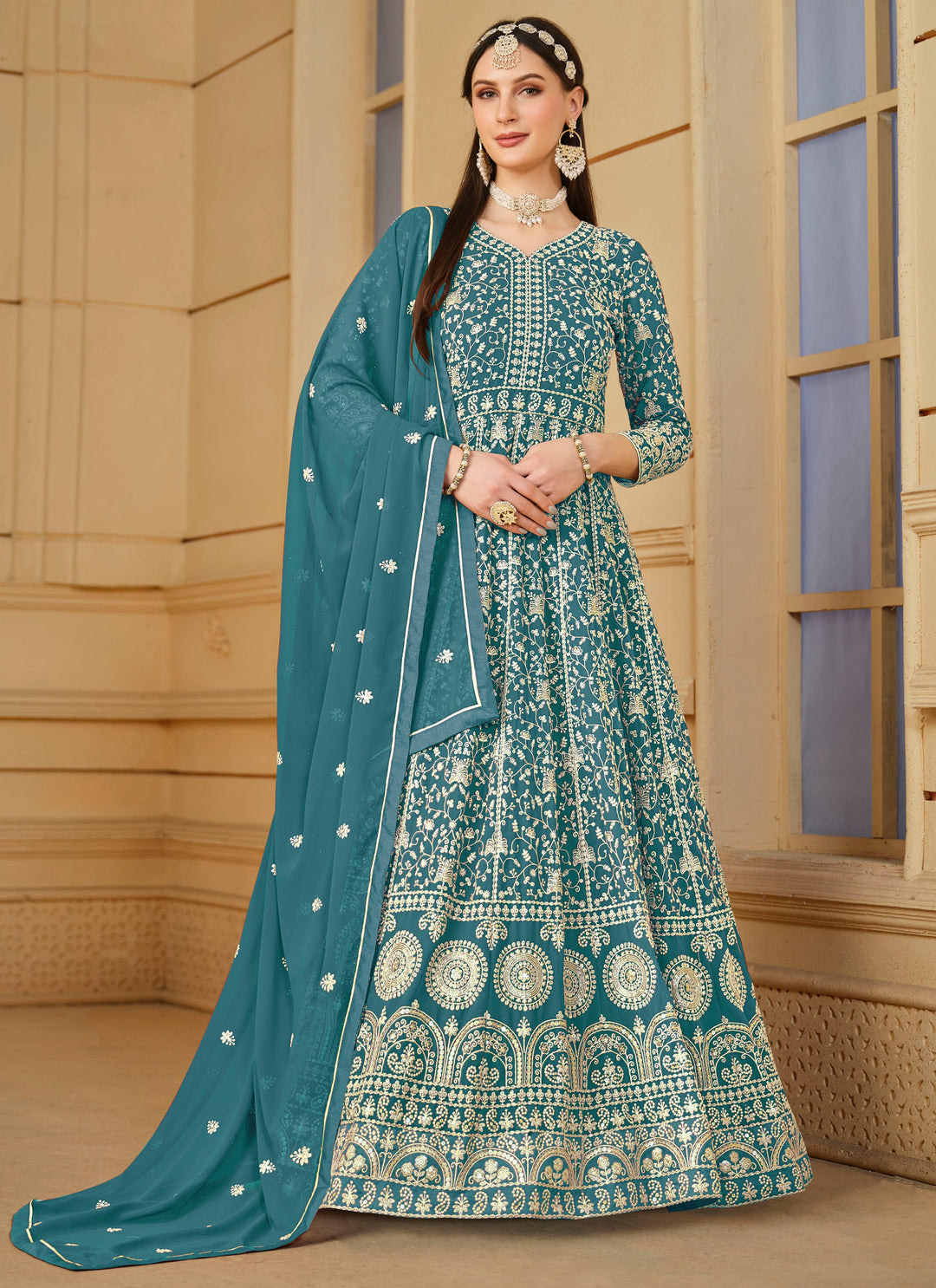 Elegant teal faux georgette salwar kameez featuring heavy thread embroidery and sequins, perfect for festive occasions.