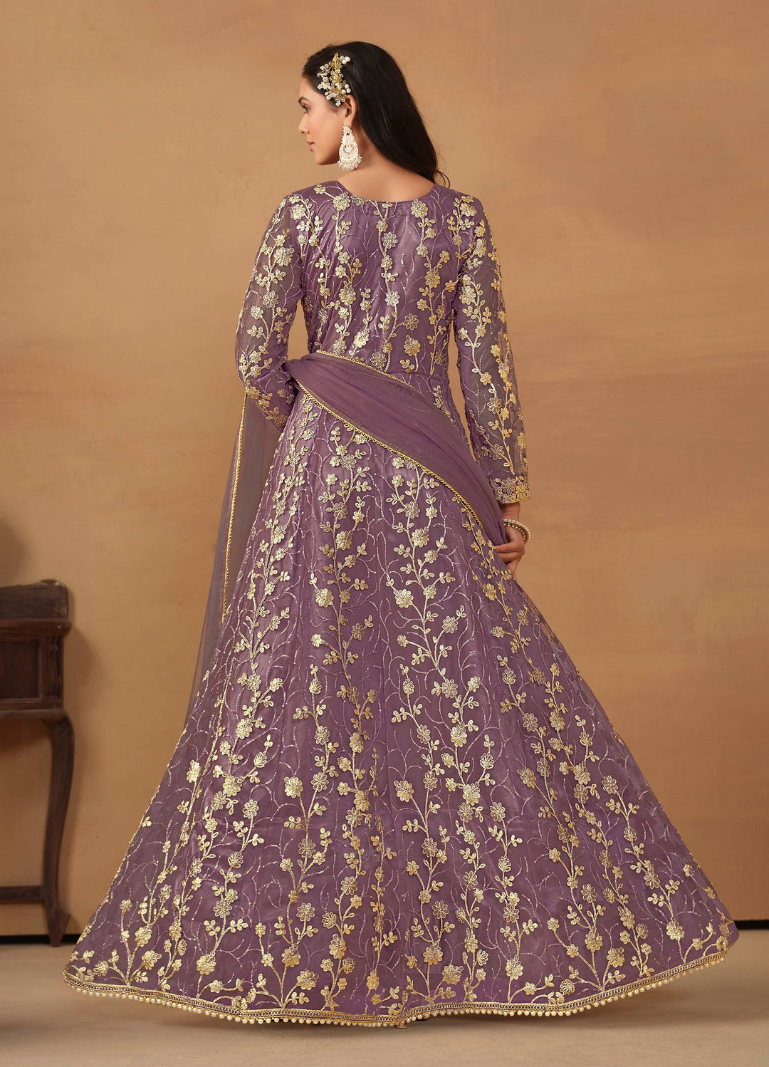 Luxurious purple net salwar kameez adorned with exquisite heavy embroidery and sequins, ideal for weddings and celebrations.