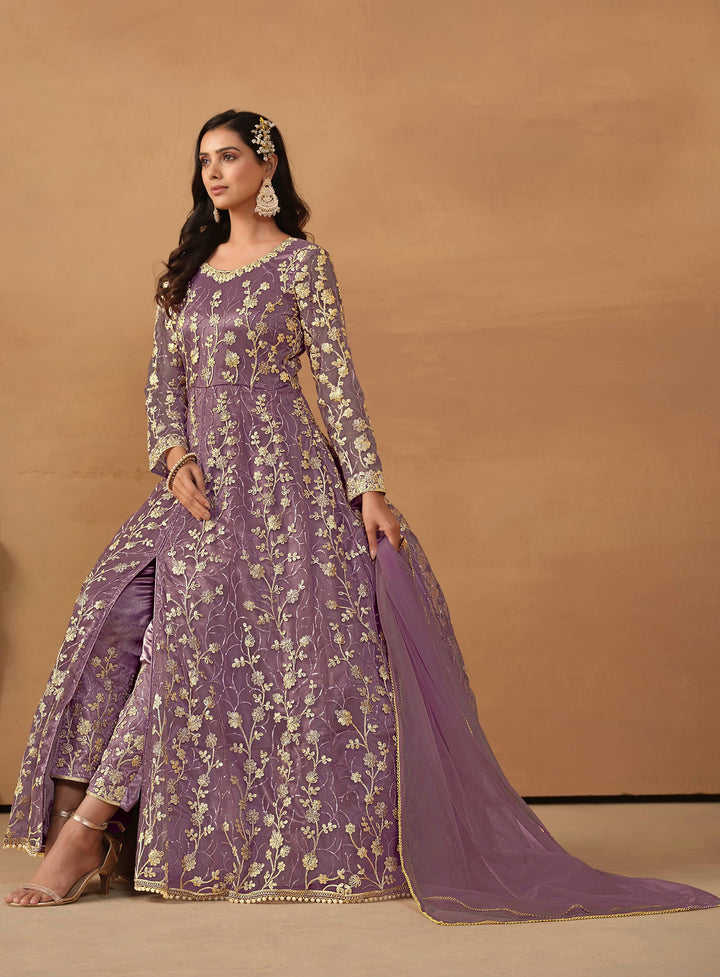 Beautiful purple salwar kameez crafted from net, showcasing intricate heavy thread and sequin embellishments.