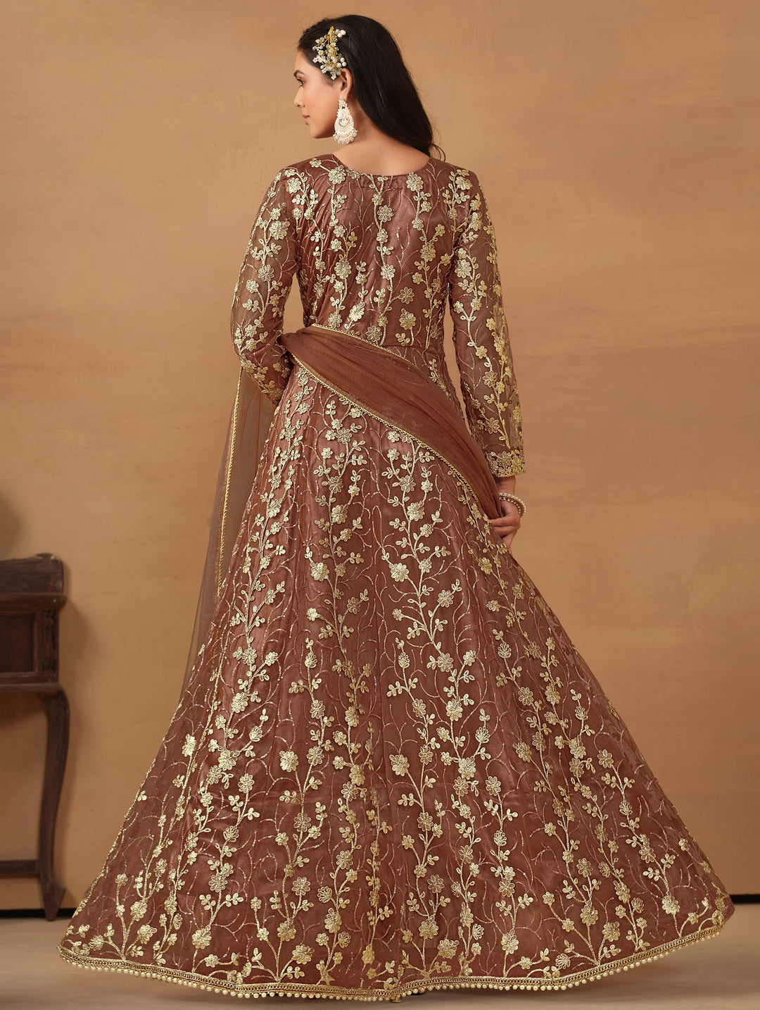 Luxurious brown net salwar kameez adorned with exquisite heavy embroidery and sequins, ideal for weddings and celebrations.