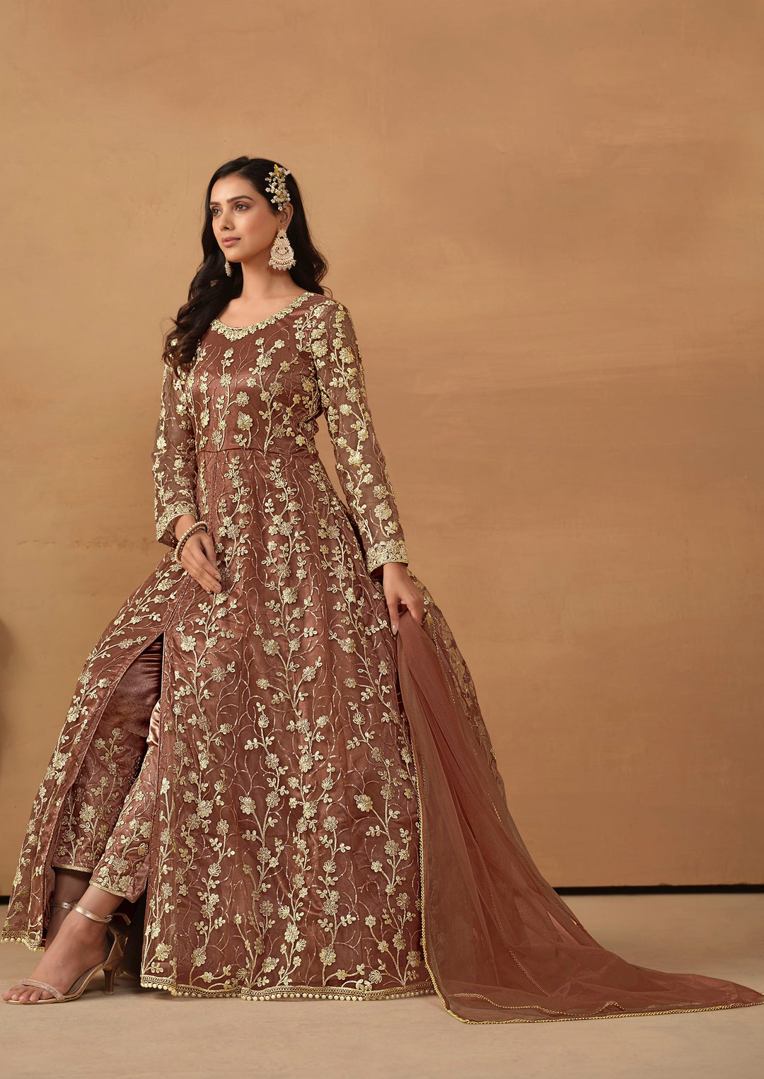 Beautiful brown salwar kameez crafted from net, showcasing intricate heavy thread and sequin embellishments.