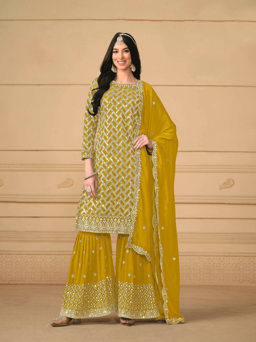 Stunning mustard salwar kameez in faux georgette with intricate thread embroidery and shimmering sequin work for special events.