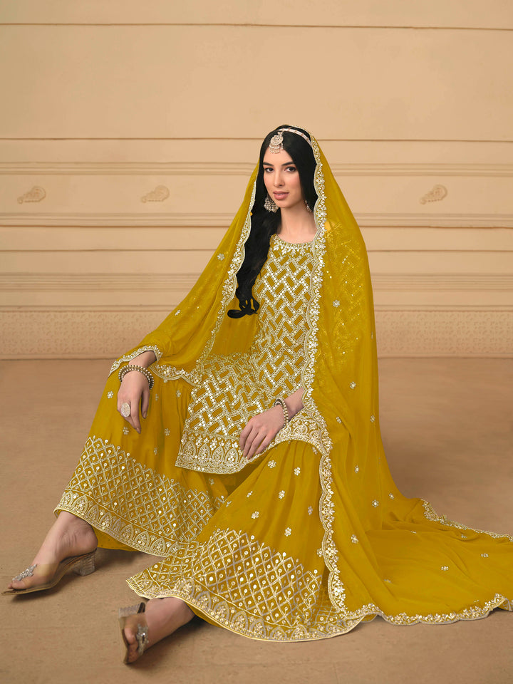 Beautiful mustard salwar kameez crafted from faux georgette, showcasing intricate heavy thread and sequin embellishments.