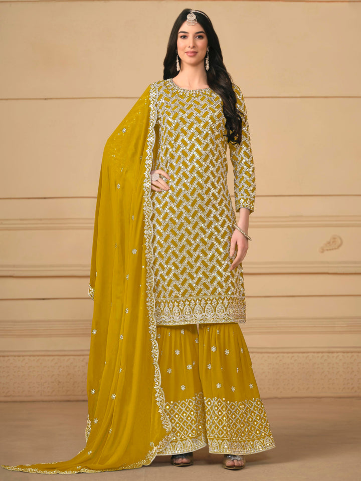 Elegant mustard faux georgette salwar kameez featuring heavy thread embroidery and sequins, perfect for festive occasions.