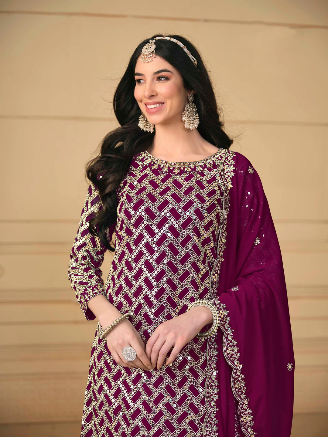 Luxurious magenta faux georgette salwar kameez adorned with exquisite heavy embroidery and sequins, ideal for weddings.