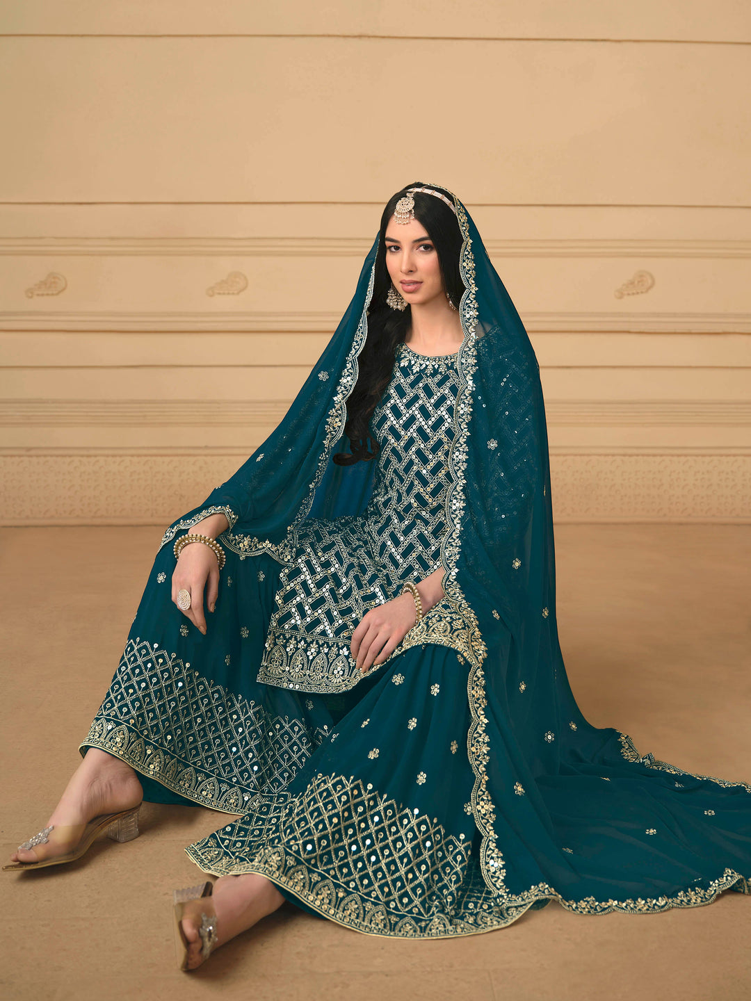 Beautiful teal blue salwar kameez crafted from faux georgette, showcasing intricate heavy thread and sequin embellishments.