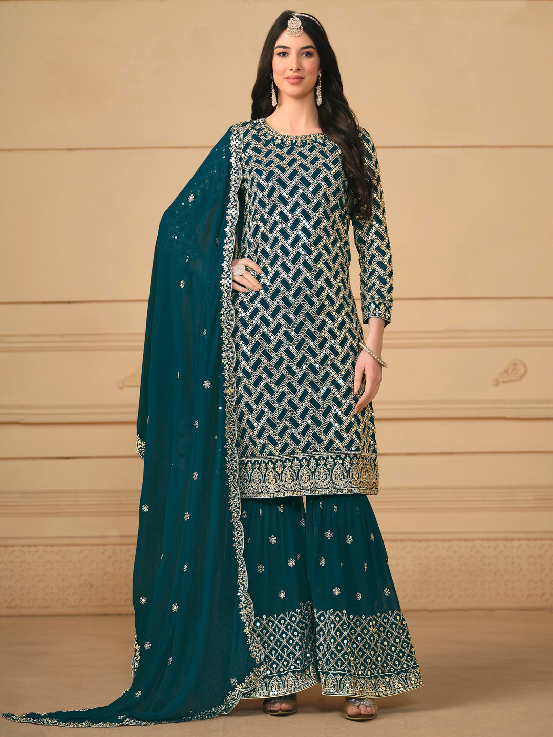 Elegant teal blue faux georgette salwar kameez featuring heavy thread embroidery and sequins, perfect for special occasions.