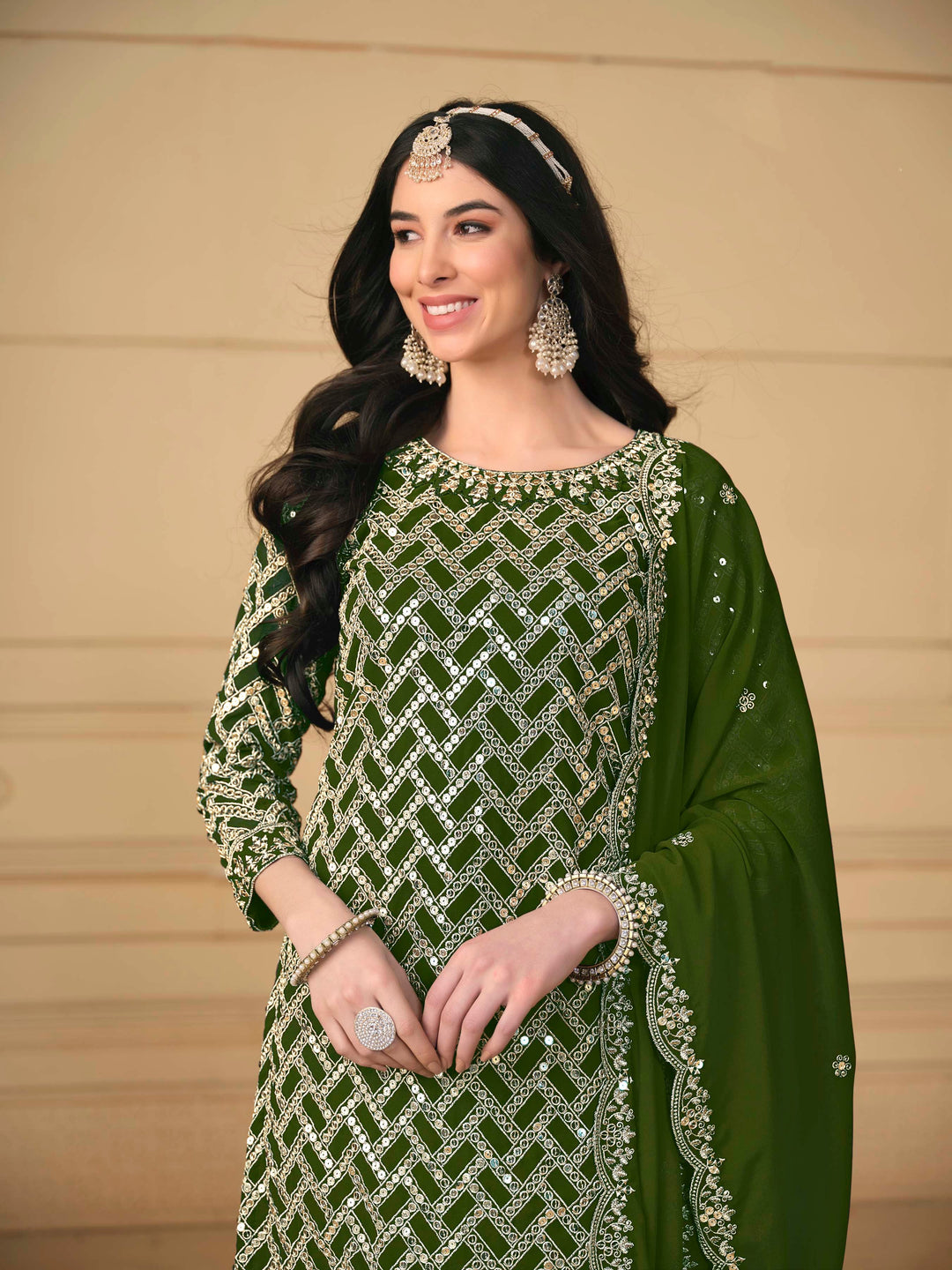 Luxurious mehendi faux georgette salwar kameez adorned with exquisite heavy embroidery and sequins, ideal for weddings.