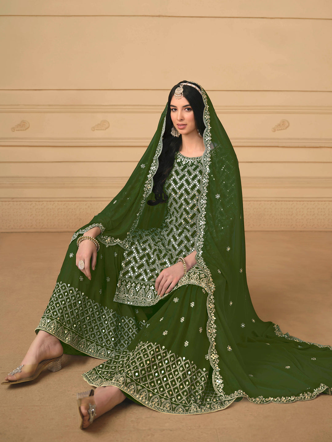 Beautiful mehendi salwar kameez crafted from faux georgette, showcasing intricate heavy thread and sequin embellishments.