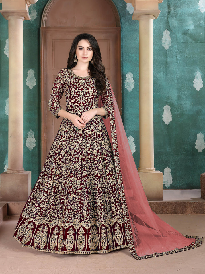 Richly embroidered maroon Anarkali suit, perfect for festive occasions, featuring exquisite detailing and elegant design.