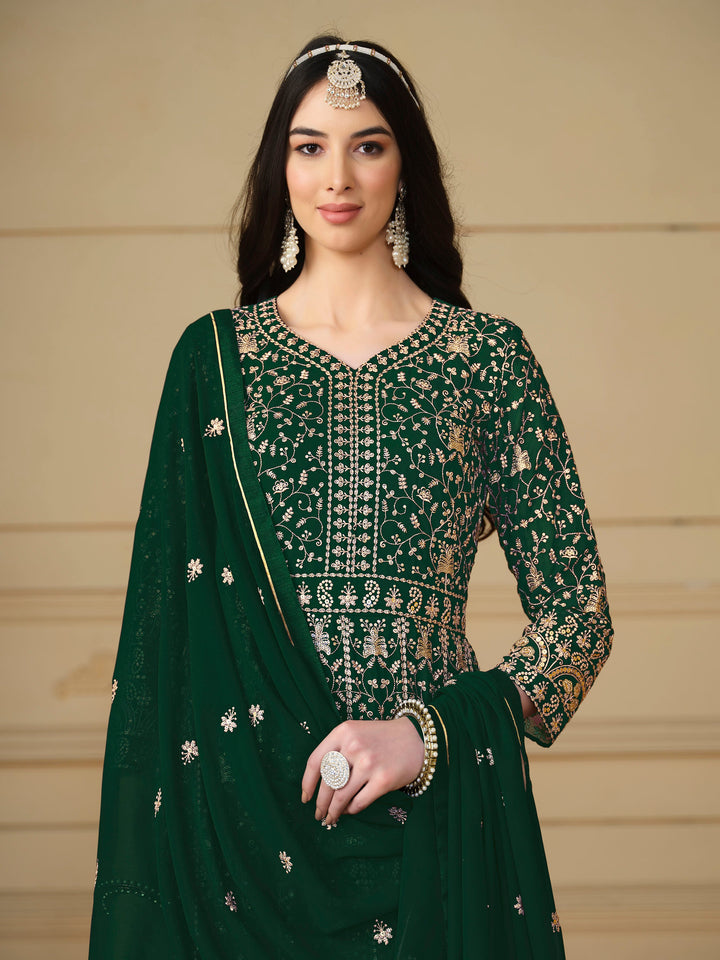 Luxurious dark green faux georgette salwar kameez adorned with exquisite heavy embroidery and sequins, ideal for weddings.