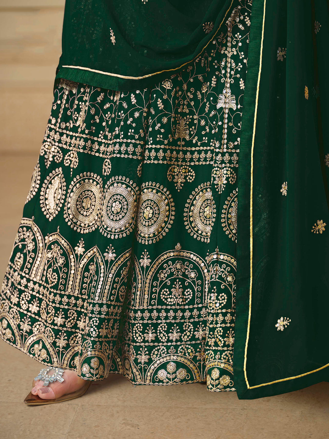 Beautiful dark green salwar kameez crafted from faux georgette, showcasing intricate heavy thread and sequin embellishments.