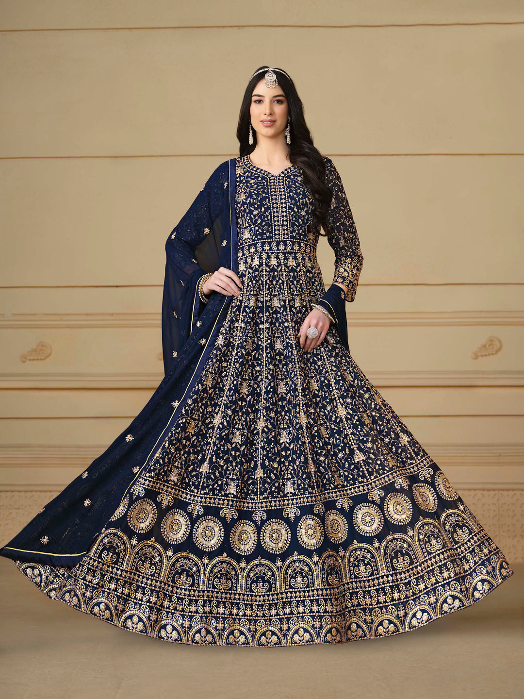 Stunning navy blue salwar kameez in faux georgette with intricate thread embroidery and shimmering sequin work for festive events.