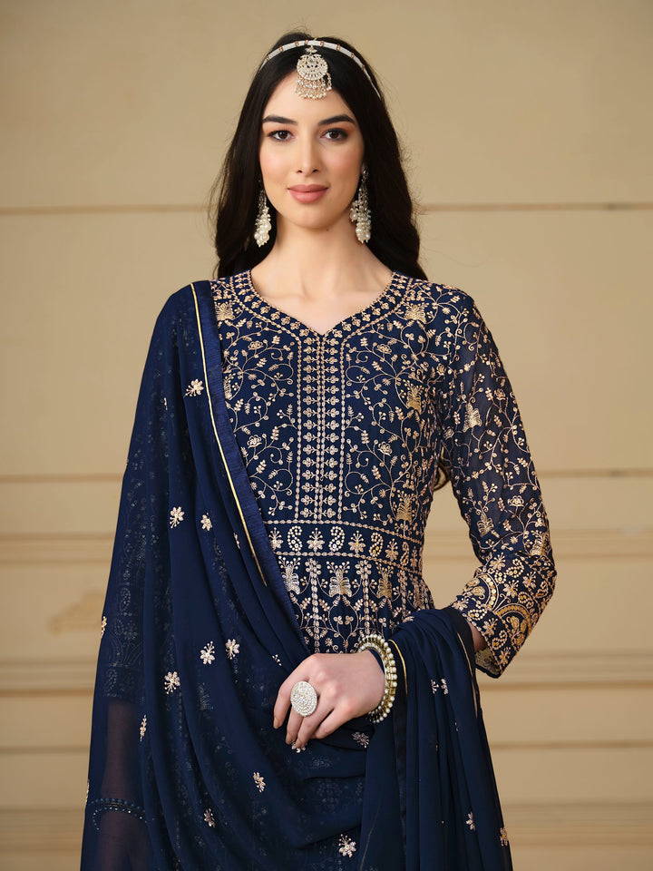 Luxurious navy blue faux georgette salwar kameez adorned with exquisite heavy embroidery and sequins, ideal for weddings.