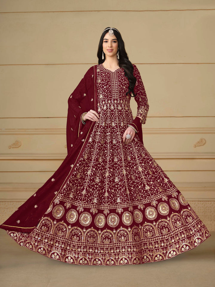 Stunning maroon salwar kameez in faux georgette with intricate thread embroidery and shimmering sequin work for festive events.