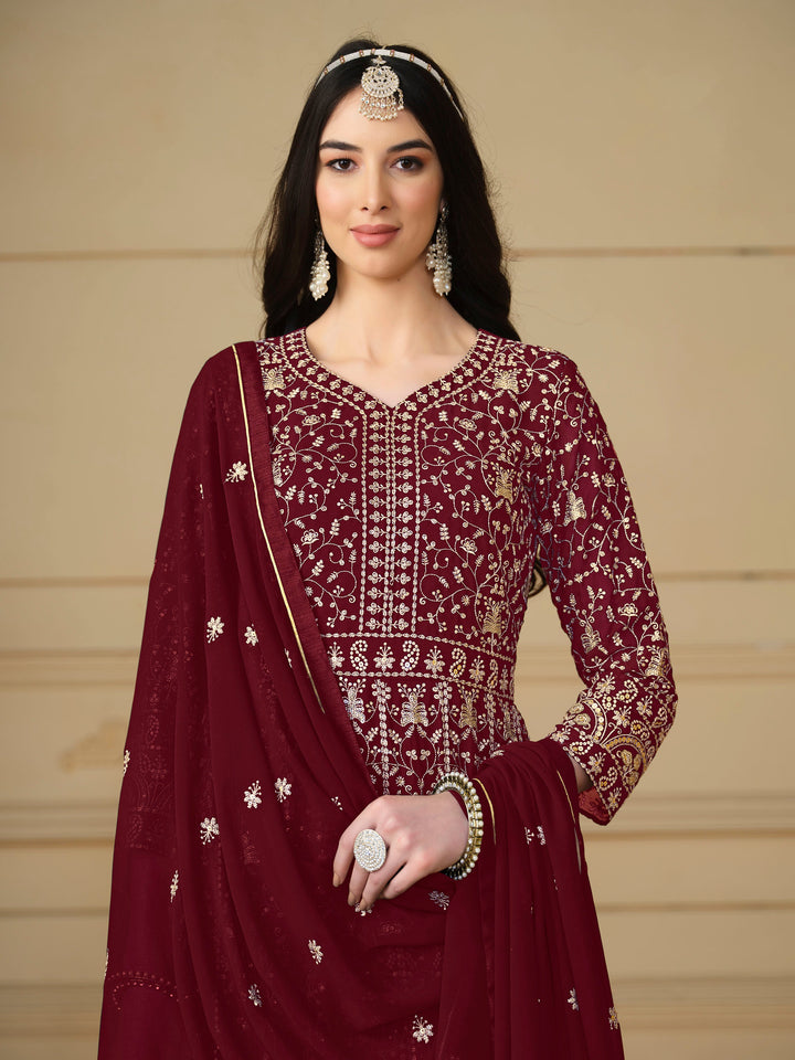 Luxurious maroon faux georgette salwar kameez adorned with exquisite heavy embroidery and sequins, ideal for weddings.