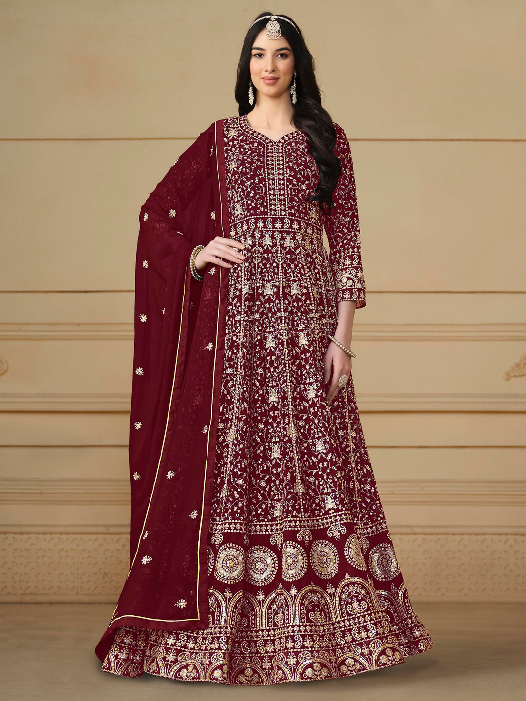 Elegant maroon faux georgette salwar kameez featuring heavy thread embroidery and sequins, perfect for special occasions.