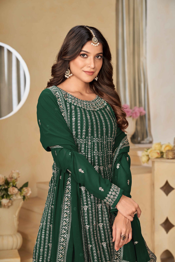 Luxurious dark green faux georgette salwar kameez adorned with exquisite heavy embroidery and sequins, ideal for weddings.