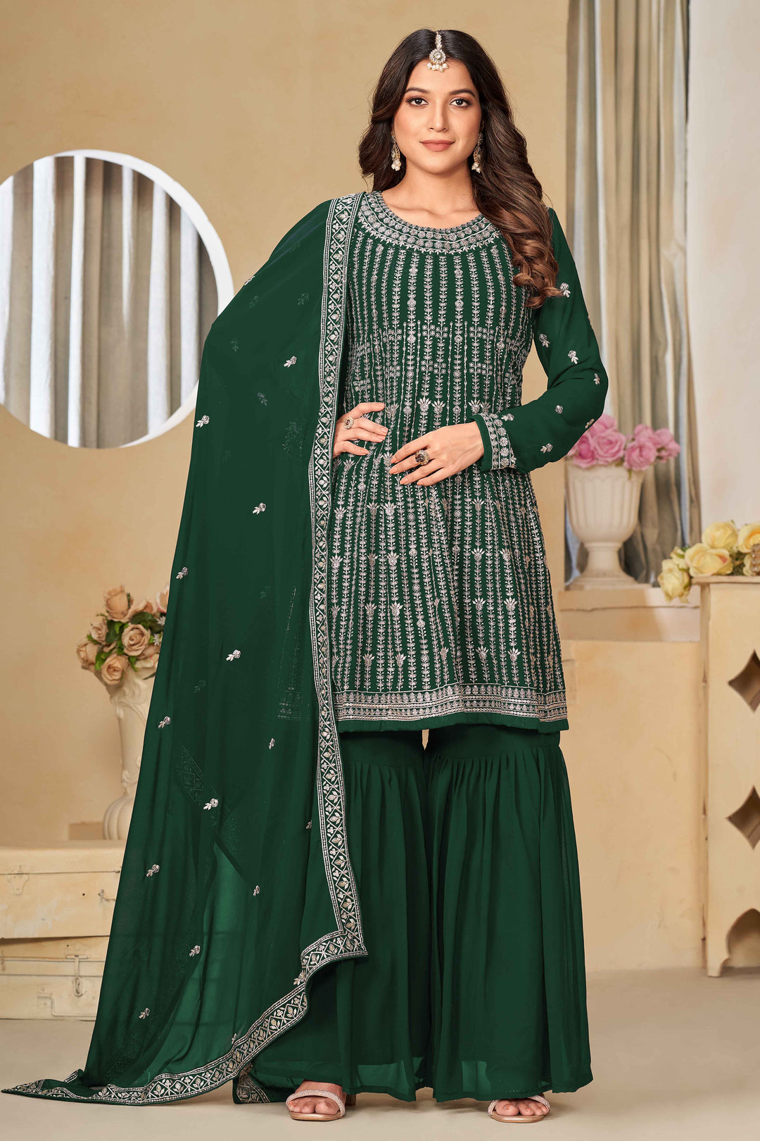 Elegant dark green faux georgette salwar kameez featuring heavy thread embroidery and sequins, perfect for special occasions.