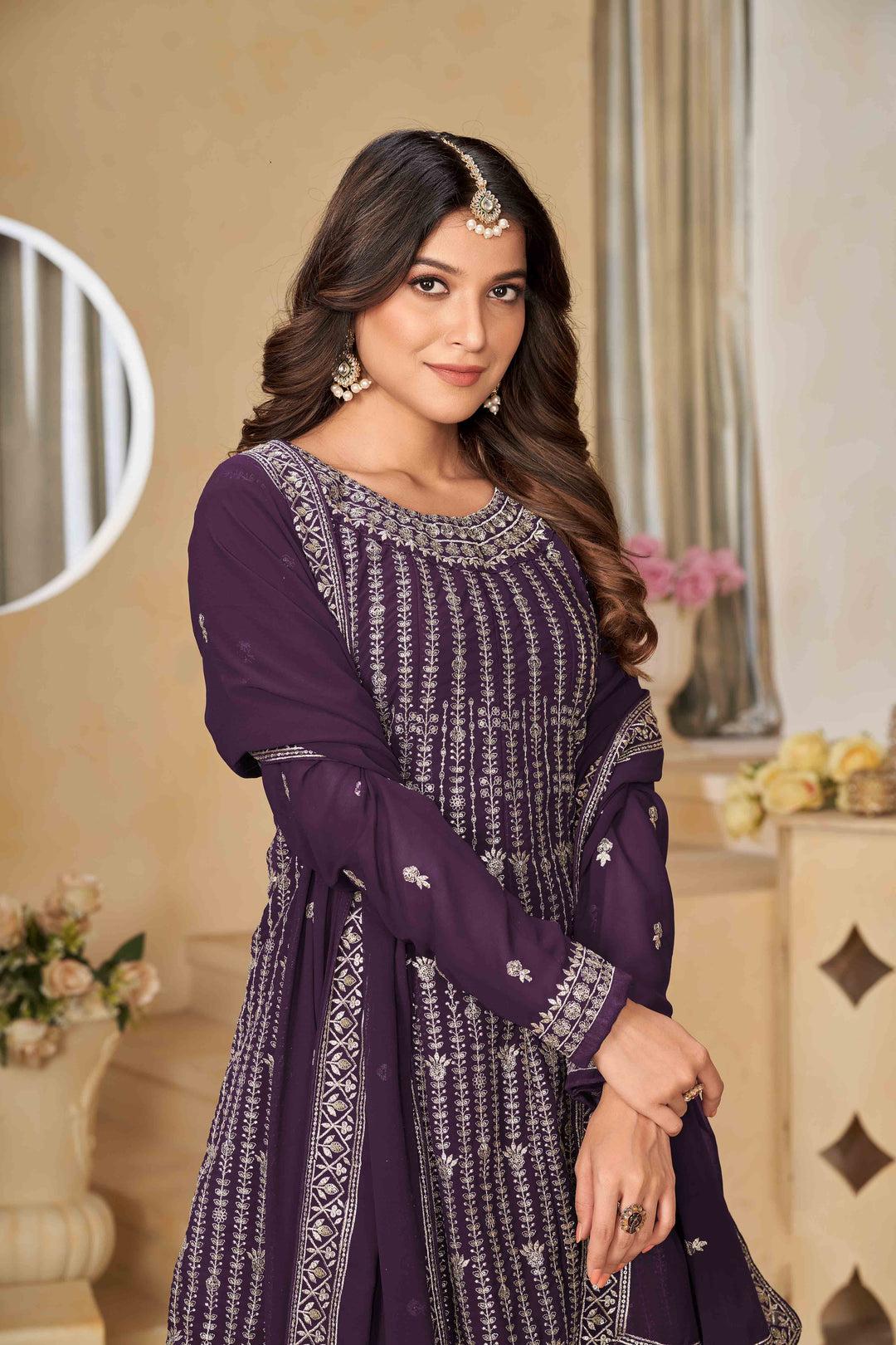 Luxurious purple faux georgette salwar kameez adorned with exquisite heavy embroidery and sequins, ideal for weddings.